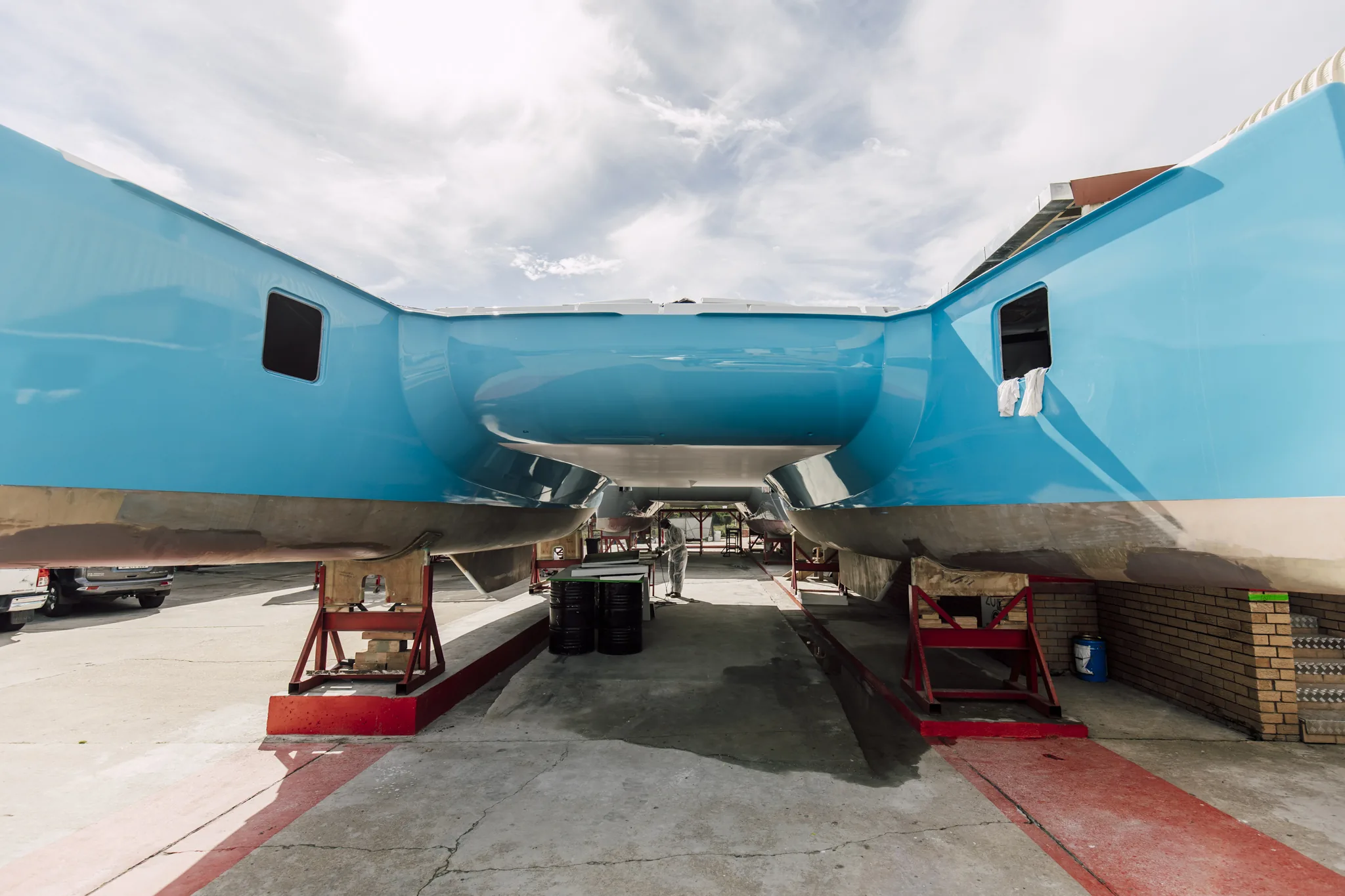 The same hull finished in gloss blue, seen end-on from under the bridgedeck