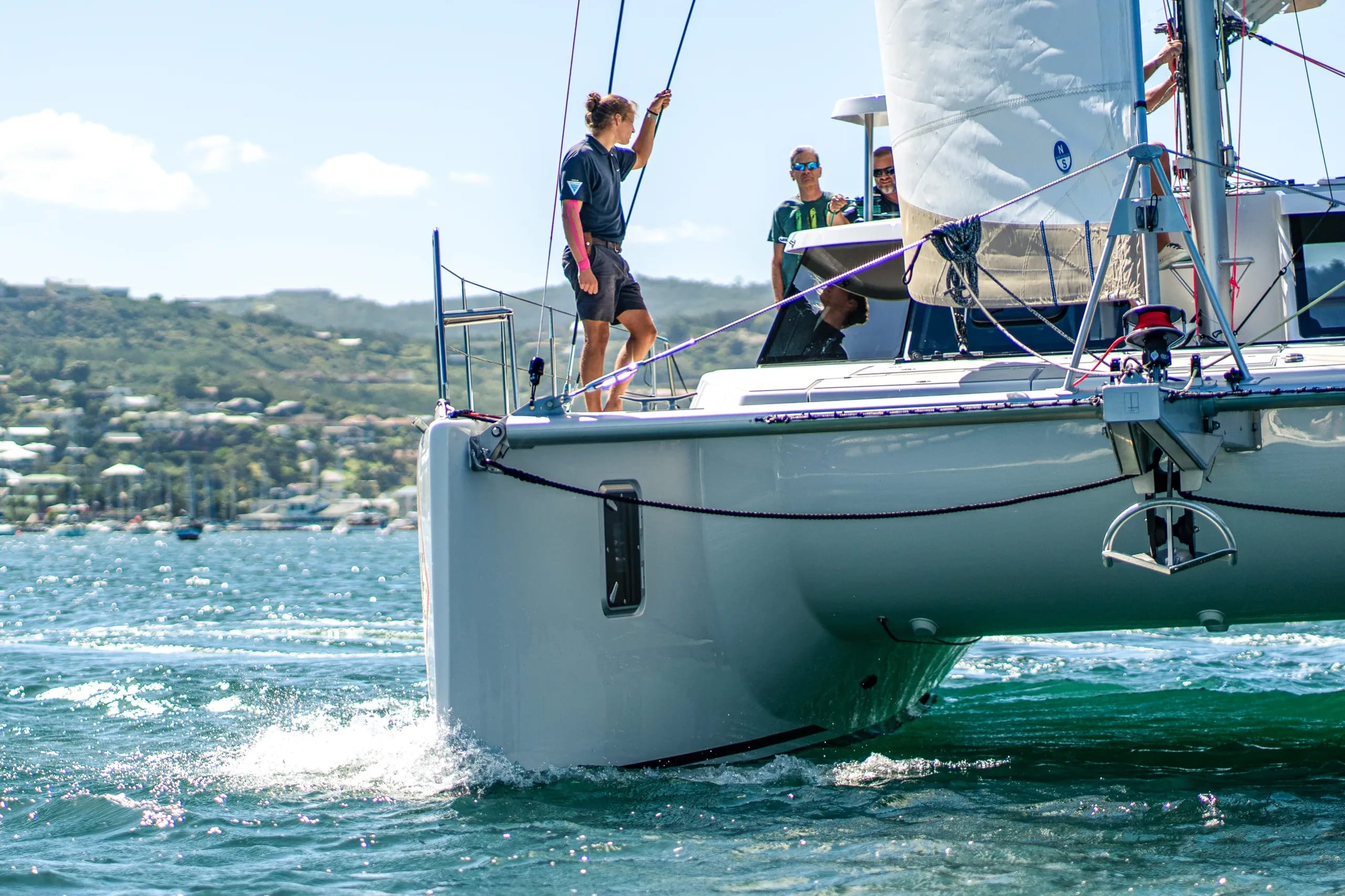 Crew on the foredeck of a Vision catamaran