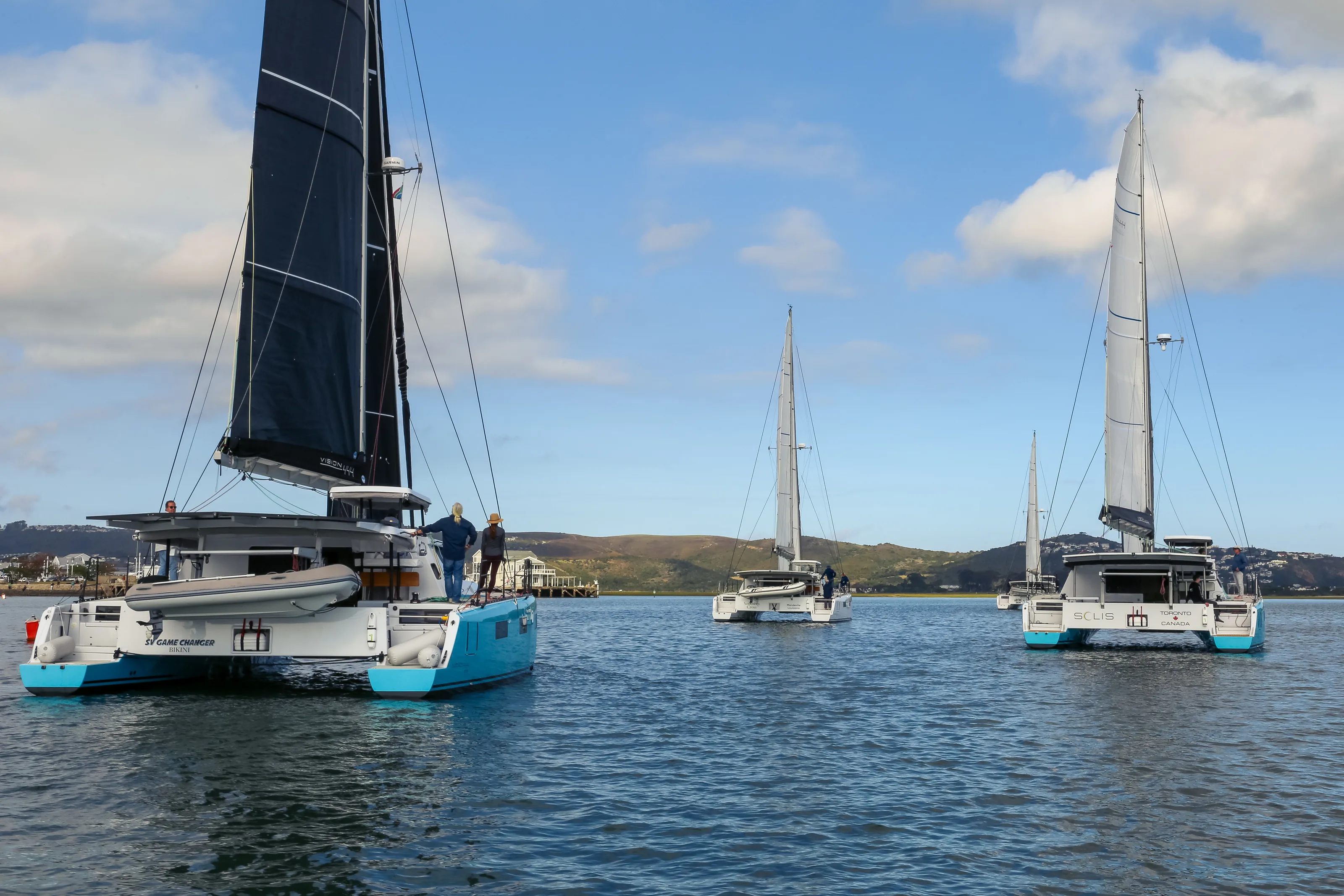 Five Vision catamarans moored in a row on the Knysna lagoon