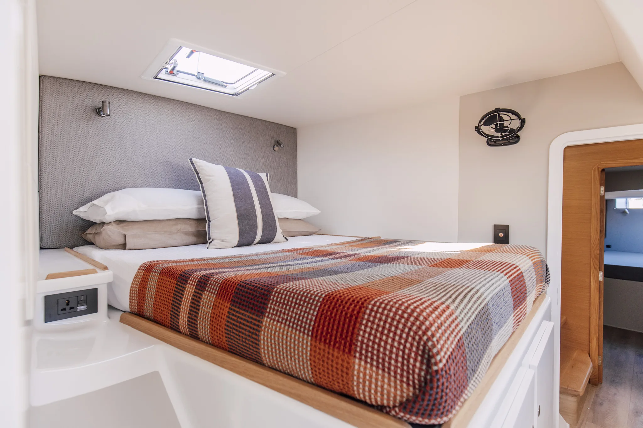 The owner's cabin of a Vision, the berth made up beneath the deck hatch